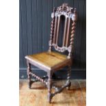 A Victorian oak hall chair in the Jacobean style, with arched carved top rail spiral twist back with