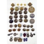 A small collection of military brass buttons, RAF cap badge, lapel badges etc.