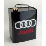 A reproduction Audi petrol can, with Audi in red silver logo rings to a black ground.