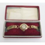 An 18ct Gold Cased Ladies Wristwatch on a gold plated bracelet. Running