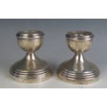 A pair of George V silver desk candlesticks, maker Sanders & Mackenzie, Birmingham, 1913, with urn-