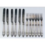 A set of six silver handled fruit knives and forks, with steel tines and blades, and filled