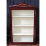 An Edwardian mahogany glazed wall display cabinet for Holman, Ham & Co, Exeter, of arched outline.