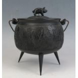An Irish bog oak carved miniature swing-handled cauldron and cover, of circular form, the cover