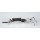 A pair of silver plated candle snuffers with scissor action and spring loaded wick trimmer, raised