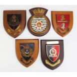 A collection of Mess and ward room regimental crests and badges mounted on shield-shaped plaques. (