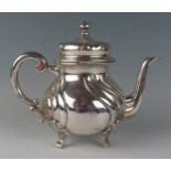 A German silver circular teapot, stamped marks, of ovoid writhen form, with scroll handle, and