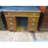 A 19th century mahogany campaign twin pedestal writing desk, the top with tooled leather writing