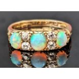 An 18ct Gold, Opal and Diamond Ring, 18mm wide head, hallmarked, size O.25, 4.45g. Marks rubbed,