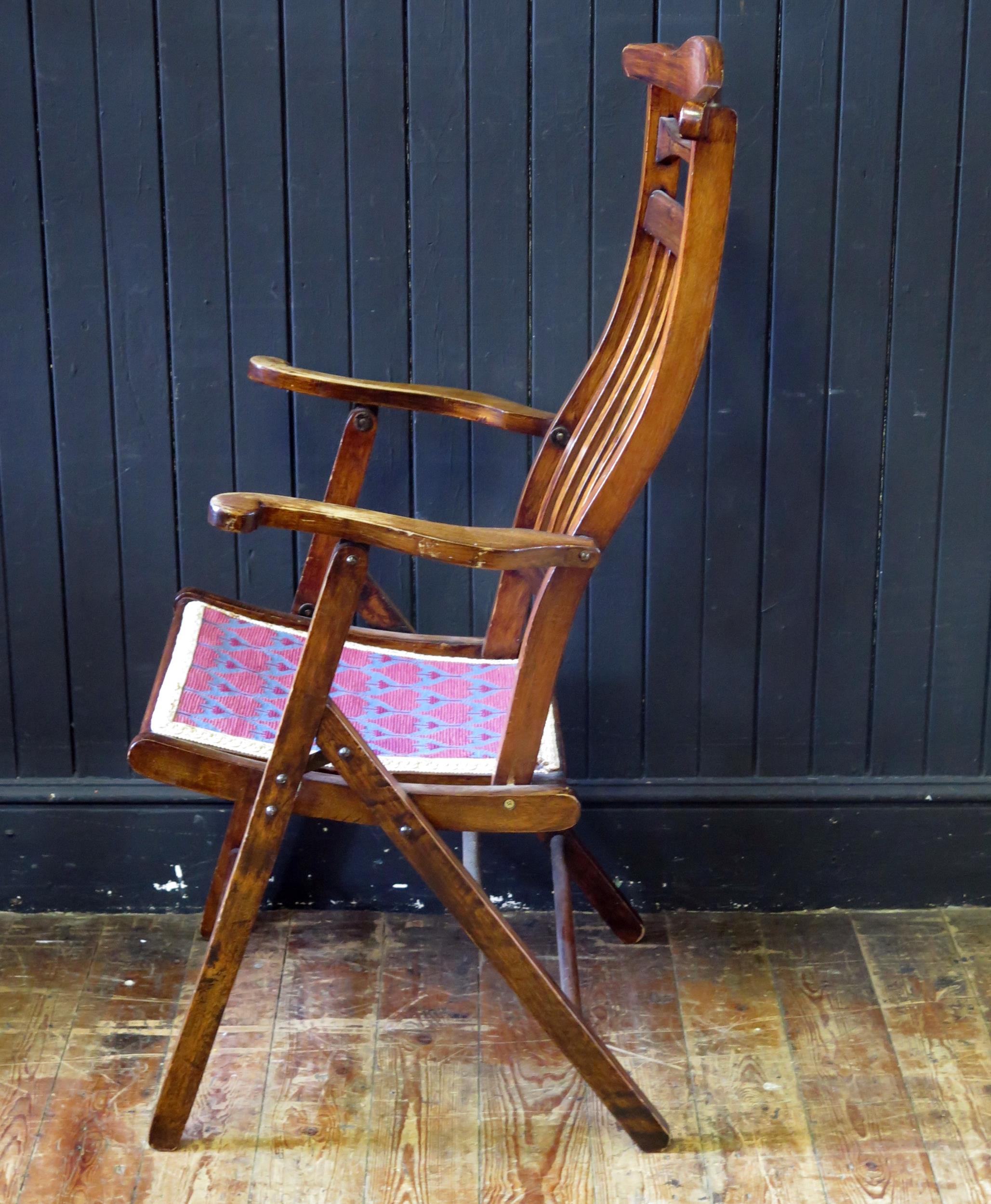 A stained beech folding elbow chair, with arched top rail and slat back, having a gross point wool - Image 2 of 3