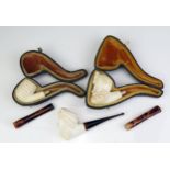 A carved meerschaum pipe in the form of a Turks head, lacks mouthpiece, cased, another similar