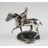 An Edward VII silver model of a horse and rider, maker John Wilmot, Birmingham, 1906, on a