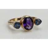 A Cabochon Amethyst and Blue Stone Ring, rub over set and in an unmarked precious yellow metal