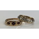 A 9ct Gold and Garnet Three Stone Ring (size N.25, c. 2.41g) and a 9ct gold and CZ eternity ring (