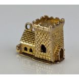 A 9ct Gold Wedding Charm in the form of a church with hinged top opening to reveal the bride and
