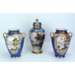 A pair of Noritake twin handles vases of ovoid outline, decorated with lakeside scenes, 19cm high,