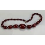 A Faux Amber Bead Necklace, 18.5" (47cm), largest bead c. 32.5 x 23.5mm, 50.96g