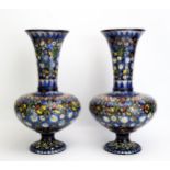 A pair of Alhambra faience vases, with trumpet-shaped necks, bulbous bodies on spreading circular