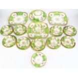 A Coalport part tea service, including cake plates, muffin dish and cover, side plates cups and