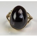 A 9ct Gold and Cabochon Garnet Dress Ring, the oval stone 15x11x8.5mm, modern hallmarks, size M, 5.
