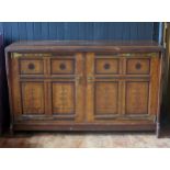 An aesthetic movement period oak side cupboard, the rectangular top with a moulded edge, above a