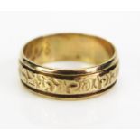 A 9ct Gold Wedding Band with foliate patternation, hallmarked, 6mm wide, size K.5, 2.86g