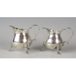A pair of miniature cream jugs, maker M Bros, Birmingham, 1896, of ovoid form with scroll handles