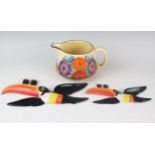 A Clarice Cliff bizarre 'Gay Day' pattern cream jug, 15cm long together with two Carlton ware