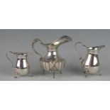 A continental silver cream jug, stamped marks with flared spout, lobed body on three swept feet,