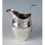 A George III silver cream jug, makers mark worn and rubbed, London, 1802, crested, of barge-shaped