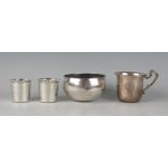 Two continental silver tots, a white metal beaten bowl and a plated mug,