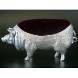 A continental silver novelty pin cushion, stamped 800, in the form of a pig, 11cm long.
