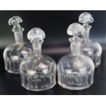 A set of four German Deutsche Bank clear glass mallet shaped decanters and stoppers with slice cut