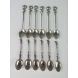 A set of six continental silver coffee spoons, with oval bowls, slender stems and floral