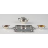 A continental silver three-piece tea service and tray, stamped marks, of oval form with half