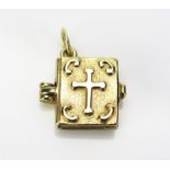 A 9ct Gold Articulated Bible Charm opening the Lord's Prayer and the Lord is my Shepherd....,