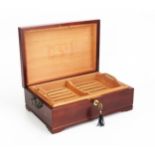 A mahogany and chequer strung humidor, of rectangular outline, the hinged lid enclosing a slotted