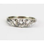 A Platinum and Diamond Three Stone Ring, c. 4.8mm principal stone flanked by 3.5mm stones, size M.5,