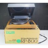 A Rotel RP-1500 turntable, contained in its original cardboard packaging.