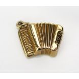 A 9ct Gold Accordion Charm, hallmarked, .81g