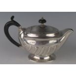 A silver bachelors teapot, maker Atkin Brothers, Sheffield, date letter worn, of oval form, with