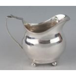 A George III silver cream jug, all marks rubbed and worn, of barge-shaped outline, with reeded