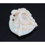 An Oriental Carved Opal Netsuke or Pendant with stylised foliate decoration, 34.5mm drop. Faults