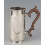 A George V silver cream jug, maker Synyer & Beddoes, Birmingham, 1927, of cylindrical outline,