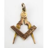 A 9ct Gold Masonic Fob in the form of a square and compass with chased decoration, hallmarked 32mm