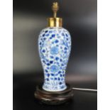 An Antique Chinese blue and white vase of 40cm. ovoid form decorated with dragons among flowering