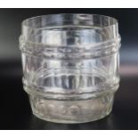 A clear glass ice bucket of barrel form with banded facetted decoration, 24cm diameter.