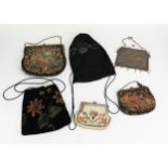 An early 20th Century chain link purse, a French beadwork purse, two machine woven purses and two