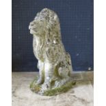 A reconstituted stone figure of a semi-recumbent lion, mounted on an oval base, 55cm high.
