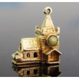 A 9ct Gold Articulated Church Charm with Stanhope viewer of the marriage vows and opening to
